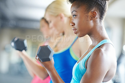 Buy stock photo Black woman, dumbbell and serious for workout in gym for fitness, class and muscle growth. Female person, weight and concentrated for exercise in center for training, sport and strength development