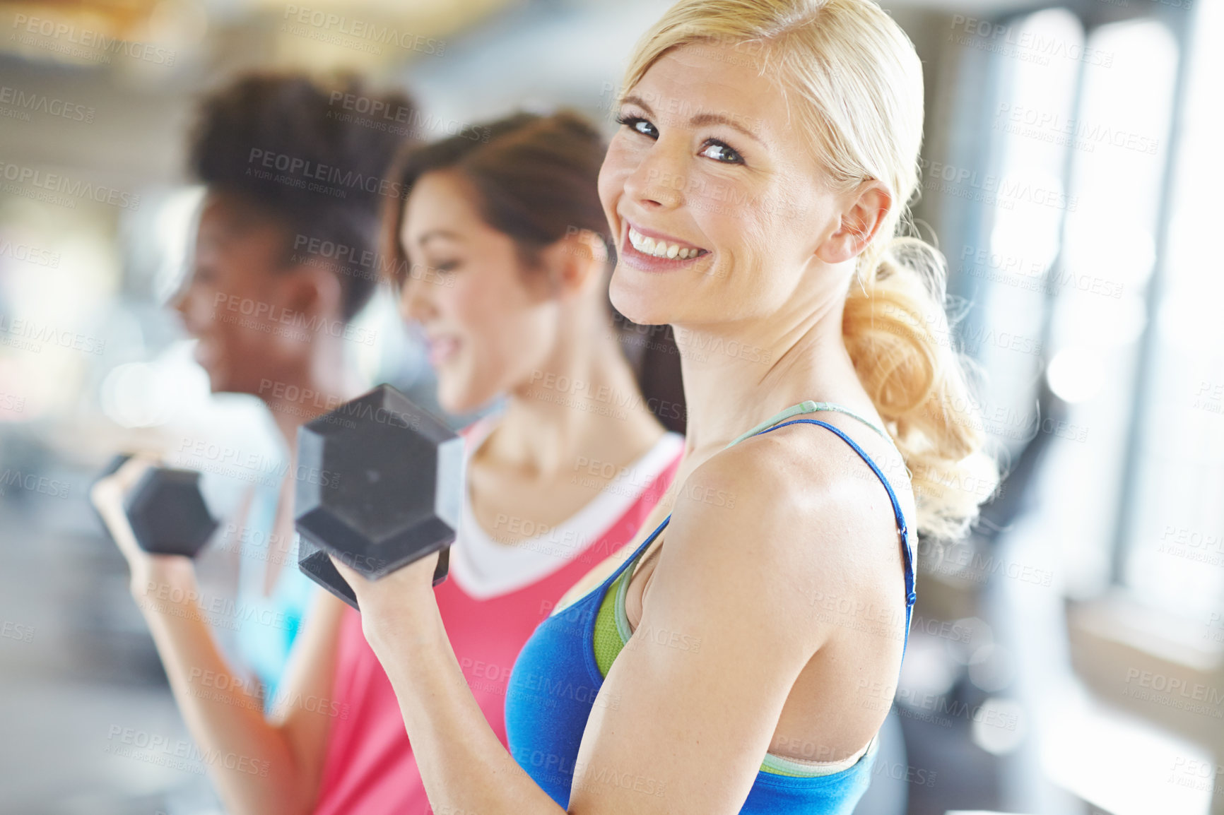 Buy stock photo Portrait, dumbbell and happy woman in gym for exercise, training or fitness with friends. Face, smile and strong girl weightlifting for workout, wellness or muscle for healthy body at sports club