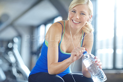 Buy stock photo Earphones, water and portrait of woman athlete in gym listening to music, radio or podcast. Smile, fitness and female person with h2o drink for hydration with sports exercise, workout or training.