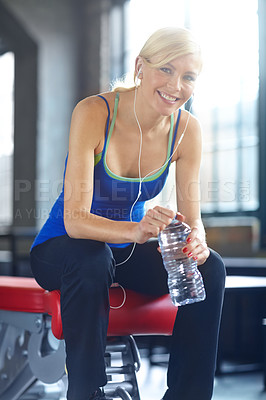 Buy stock photo Headphones, gym and portrait of woman with water bottle, happy and music with smile for training. Drink, sport and athlete at health and wellness club for exercise with audio and workout playlist