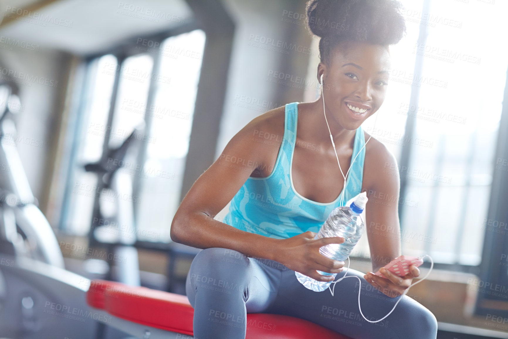 Buy stock photo Smartphone, headphones and portrait of black woman in gym with water, fitness app or online subscription. Health, wellness and girl checking music playlist on phone with bottle, break and sports club