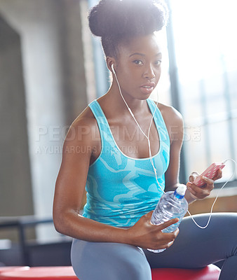 Buy stock photo Portrait, gym and black woman listening to music, water bottle and fitness with progress and healthy. Face, African person and athlete with hydration and song for exercise motivation and relaxing