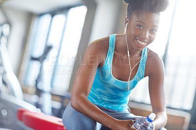 Buy stock photo Portrait, water and girl listening to music, water bottle and fitness with progress and streaming podcast. Face, African person and athlete with hydration and audio for sound and relaxing in gym