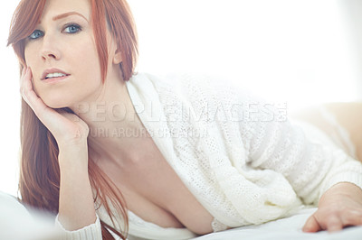 Royalty-Free photo: Woman wearing white sweater and white panty on bed  inside room