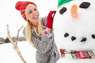 Buy stock photo Snowman, woman and happy at Christmas on winter break in Canada countryside and female building with snow for outdoor holiday tradition. Smile with nature, happiness and celebrate with festive spirit
