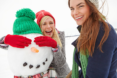Buy stock photo Snow, friends and vacation in winter with a funny snowman in cold for happy energy for US Christmas holiday portrait in winter. Festive season with women on holiday to travel, relax and have fun 