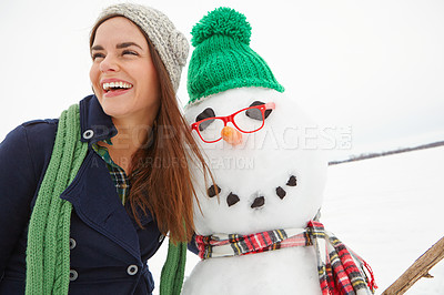 Buy stock photo Winter, snow and happy woman hugging a snowman on Christmas outside in England smiling. Holiday, festive season and xmas celebration or tradition with a female embracing a snow man on a cold day