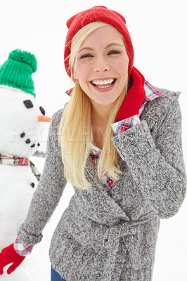 Buy stock photo Winter, snow and portrait of woman with snowman enjoying holiday, vacation and weekend in cold weather. Happiness, relax and girl smiling after decoration, ice figure and fun in nature at Christmas