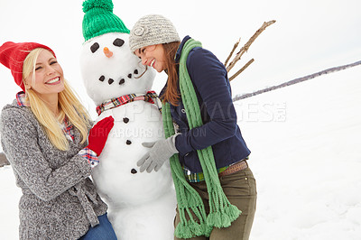 Buy stock photo Women, snow and building a snowman in winter during Christmas while having fun and bonding. Friendship, winter and xmas or festive season with ladies creating a frozen snow man in cold weather