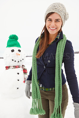 Buy stock photo Woman, snowman and happy in portrait on vacation in nature with clothes for adventure in cold. Person, ice character and outdoor with smile for playful creativity in countryside for holiday.