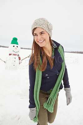 Buy stock photo Woman, snowman and smile in winter, nature and thinking on vacation, adventure or outdoor in cold. Person, snow sculpture and memory on holiday with creativity at countryside resort in Switzerland