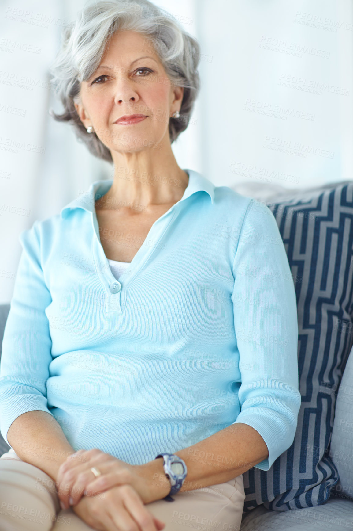 Buy stock photo Portrait, confident and senior woman in home on sofa for relax, comfort or resting alone in living room lounge. Pensioner, retirement and person on couch in casual clothes in apartment in Switzerland