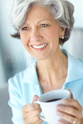 Buy stock photo Shot of a happy senior woman enjoying a cup of coffee at home