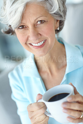 Buy stock photo Portrait of a happy senior woman enjoying a cup of coffee at home