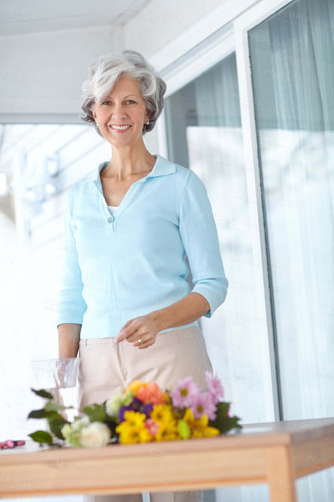 Buy stock photo Senior woman, vase and bouquet in house with portrait, smile and natural floral decoration in morning. Mature person, happy and style with flowers, hobby and glass container in home for retirement