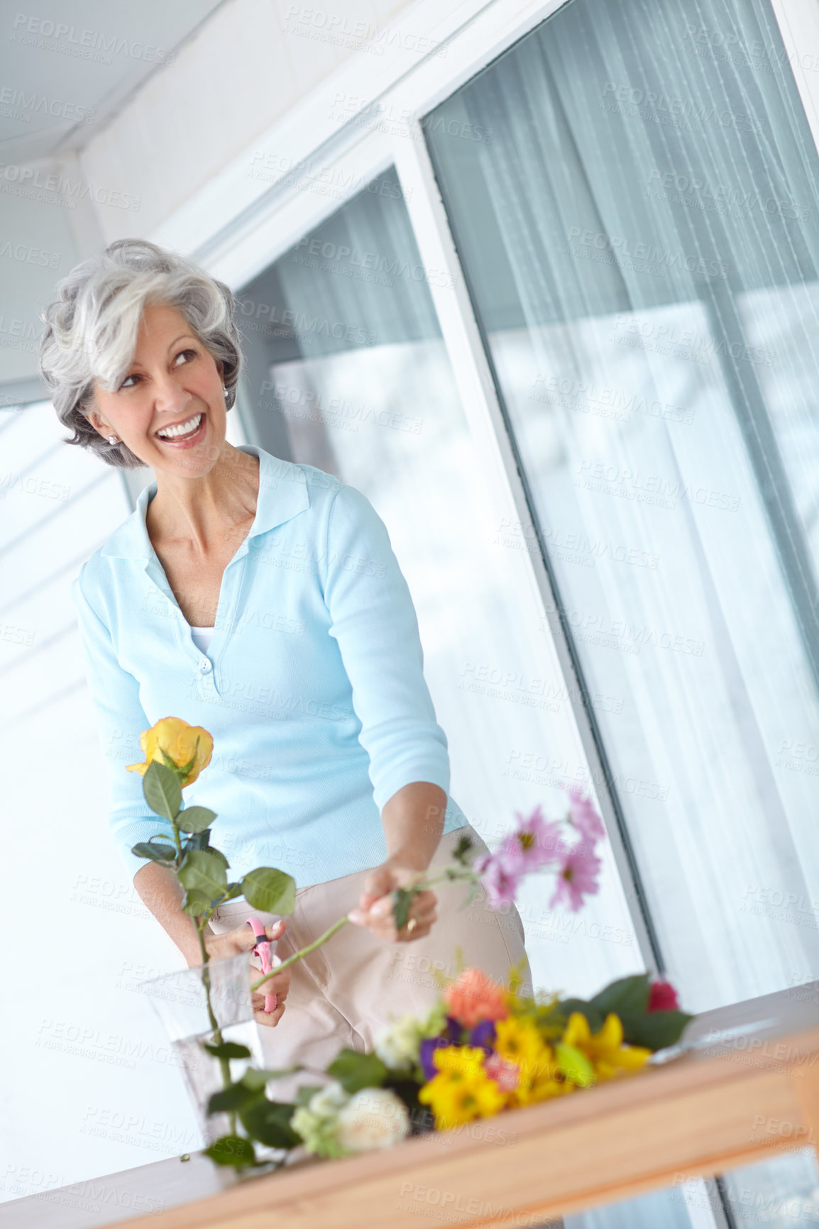 Buy stock photo Senior woman, vase and home with floral plants, thinking and smile with natural decoration in morning. Mature person, happy and style with flowers, hobby and glass container in house for retirement