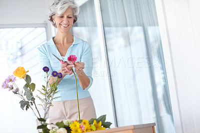 Buy stock photo Senior woman, flowers and scissor in home with thinking, smile and natural decoration in morning. Mature person, happy and tools with floral bouquet, hobby and prune plants in house for retirement