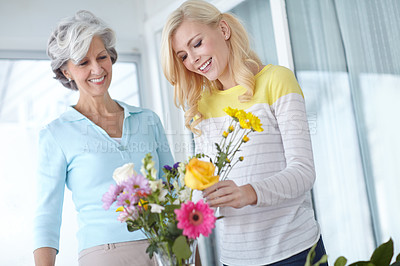 Buy stock photo Flowers, mom and happy woman with vase in home together with smile, love and wellness for affection. Mothers day, mature and daughter bonding in lounge with family, parent and gift present in Germany