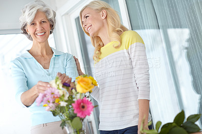 Buy stock photo Portrait, mom or happy woman with flowers in house together with joy, love and wellness for gardening. Mothers day, mature or daughter bonding in home with family, parent and gift present in Germany