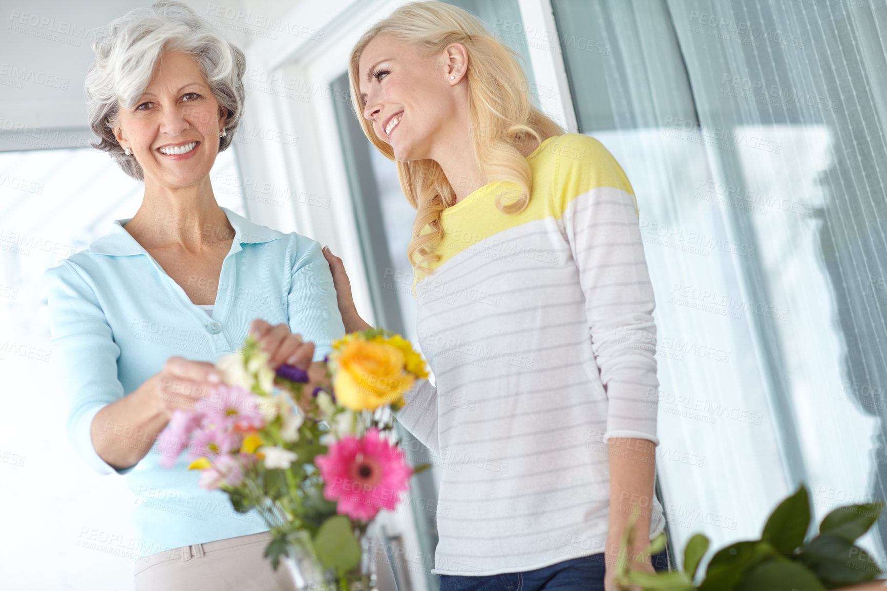 Buy stock photo Portrait, mom or happy woman with flowers in house together with joy, love and wellness for gardening. Mothers day, mature or daughter bonding in home with family, parent and gift present in Germany