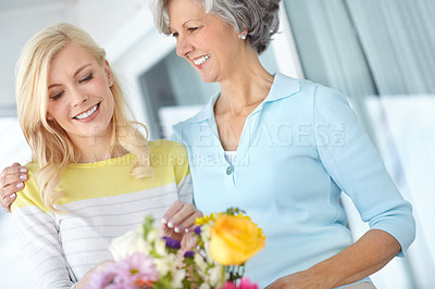 Buy stock photo Hug, parent or happy woman with flowers in house together with love, pride and wellness for gardening. Mothers day, mature and daughter bonding in home with family, mom or gift present in Germany