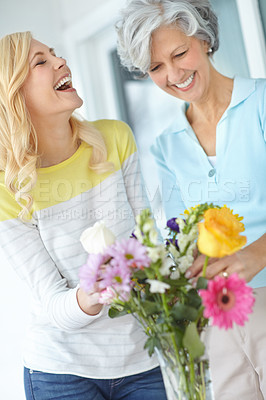 Buy stock photo Shot of a senior woman enjoying some flower arranging with her daughter