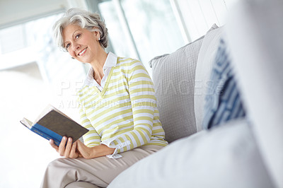 Buy stock photo Senior woman, book and portrait on sofa in home with smile, literature or relax with poetry in retirement. Mature person, reading and happy with mystery, fantasy or knowledge on lounge couch in house