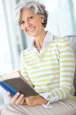 Buy stock photo Senior woman, book and portrait in home on sofa with smile, literature or relax with poetry in retirement. Mature person, reading and happy with mystery, fantasy or knowledge on lounge couch in house