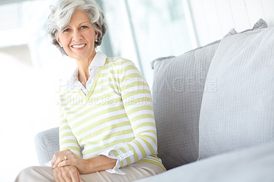 Buy stock photo Senior, portrait and happy woman in retirement or home to relax in living room with calm morning routine. Elderly, person and smile on face on couch in house with vitality and wellness on weekend