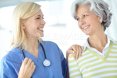 Buy stock photo Shot of a happy senior woman visiting her doctor for a checkup