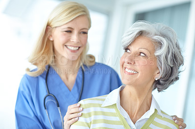 Buy stock photo Nurse, woman and mature happy for support, healthcare and hand on shoulder with medical worker in hospital. Appointment, checkup and caregiver for trust with professional, patient and smile together