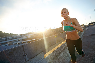 Buy stock photo Shot of an attractive young woman out on her morning run