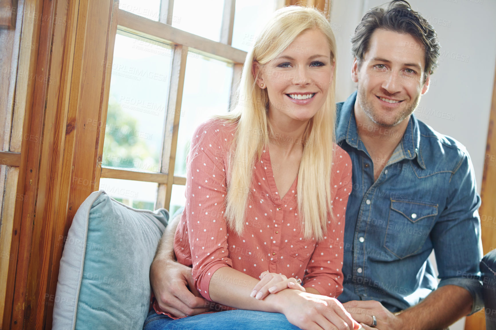 Buy stock photo Smile, portrait and happy couple on couch with love, care and bonding in home. Embrace, man and woman on sofa relaxing, romantic and enjoying conversation, relationship and weekend in living room