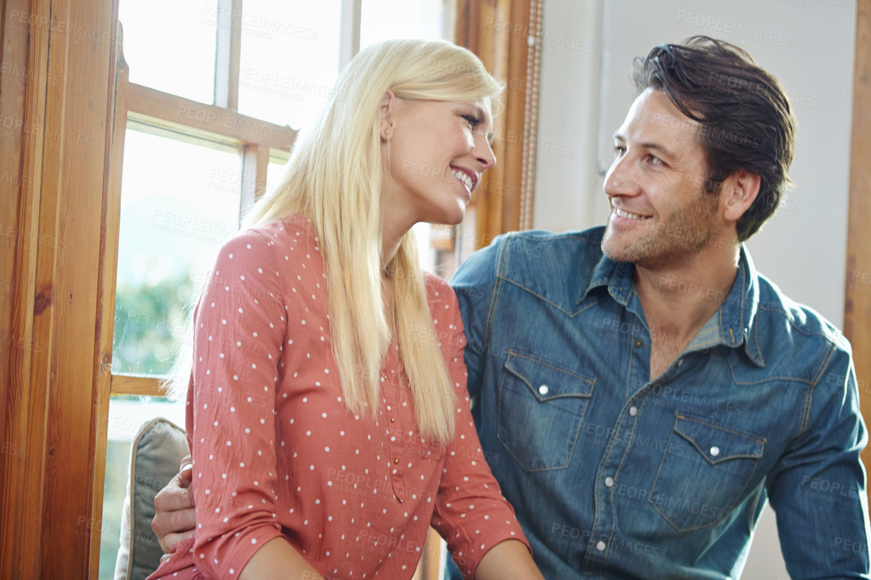 Buy stock photo Couple, happiness and relax on window bench for bonding together, hug in new apartment for support and smile. Home, happy and commitment for marriage, romantic and relationship for security with love