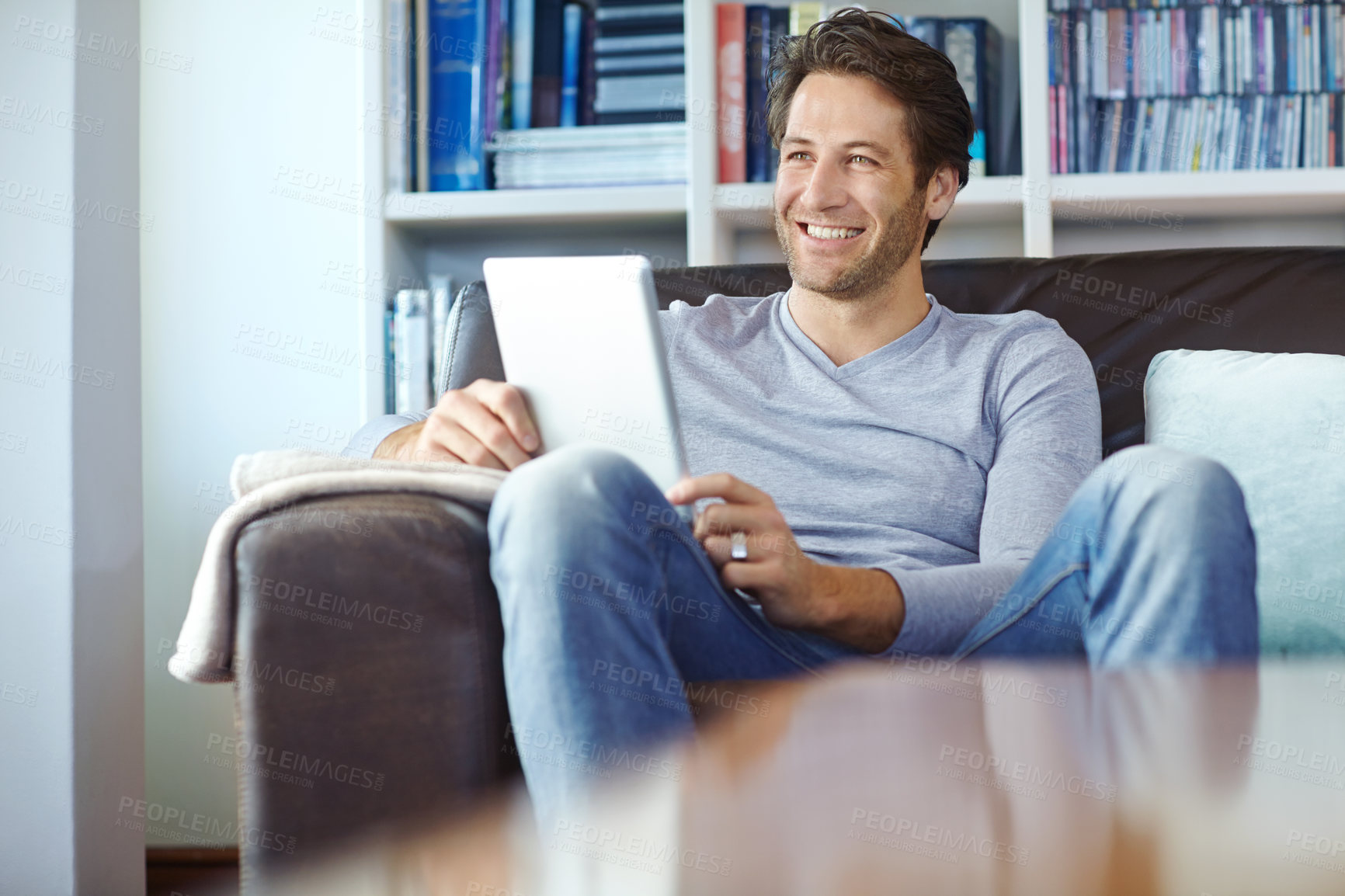 Buy stock photo Man, thinking and smile on sofa with tablet for social media memory, online gaming and morning news in lounge of home. Person, happy or digital tech for reading ebook, web search or browsing on couch