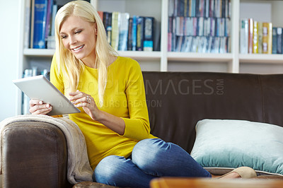 Buy stock photo Woman, relax and smile on sofa with tablet for internet surfing, online search or social media in living room of home. Person, happy and digital tech for reading ebook, web games or browsing on couch