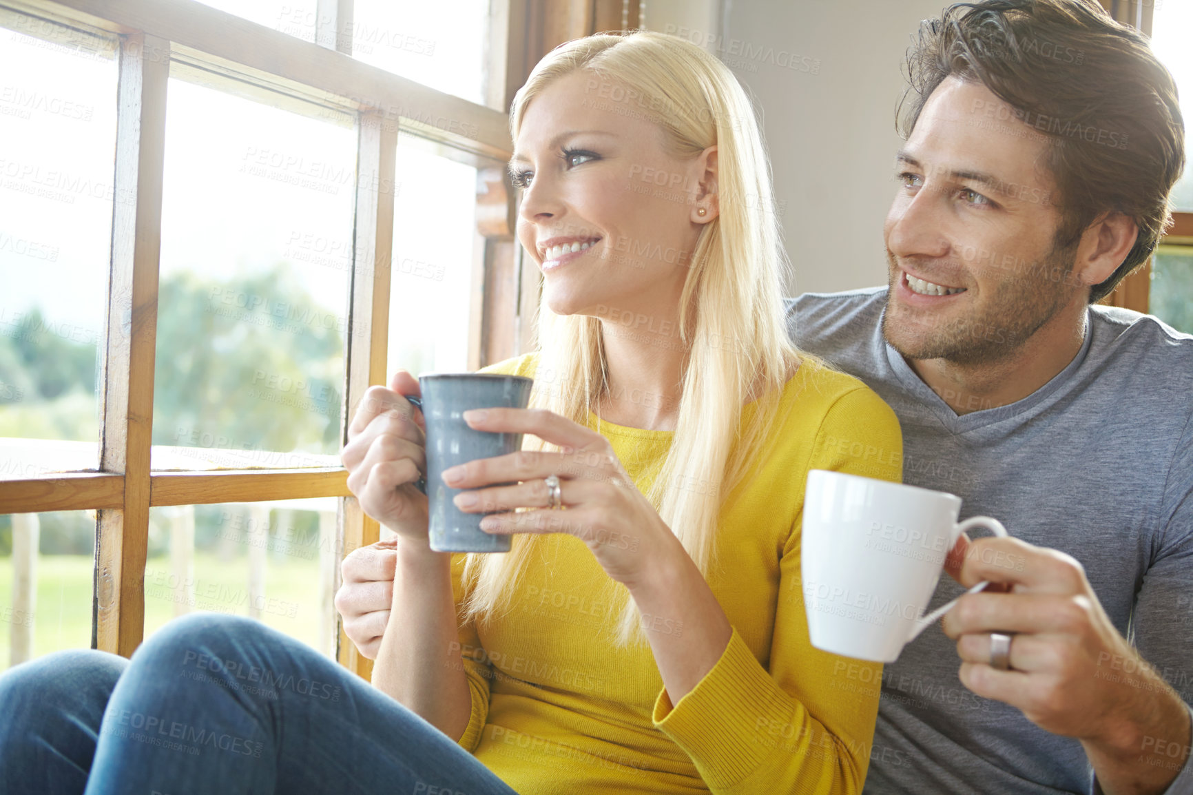 Buy stock photo Happy couple, window and thinking with coffee in relax for fun morning, holiday or weekend together at home. Young man and woman with smile for drink, beverage or cappuccino in living room at house