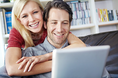 Buy stock photo Happy, couple and hugging in living room with tablet, relax online and people smile for internet browse together. Social media, web and scrolling for relationship bonding, networking and apartment