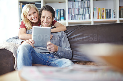 Buy stock photo Happy, couple and hugging in lounge with tablet, relax online and people smile for internet browse together. Social media, web and scrolling for relationship bonding, networking and apartment