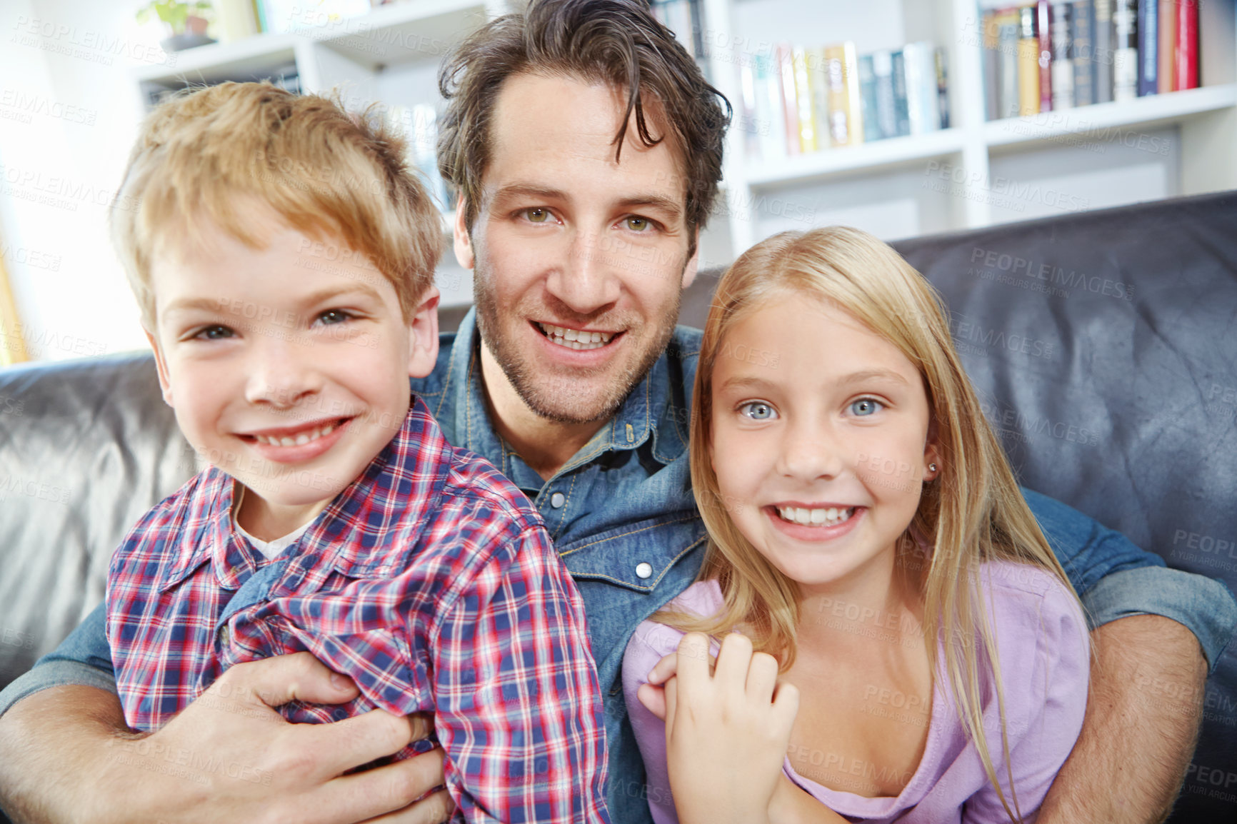 Buy stock photo Portrait, man and kids on couch with embrace, bonding and love in living room for playful family in home. Relax, father and children on sofa for happy weekend together with fun, smile and hugging.