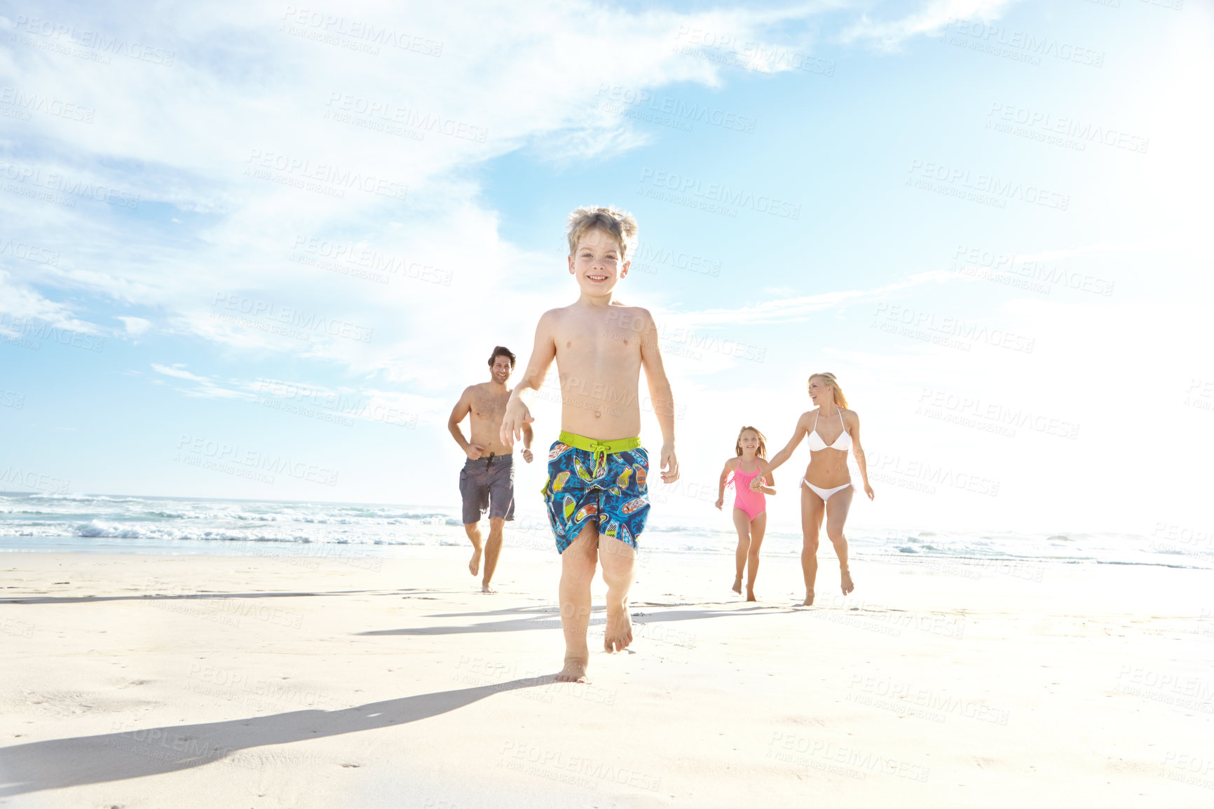 Buy stock photo Portrait, beach and running with vacation, family and happiness with weekend break, sunshine and bonding together. Parents, mother or father with children, kids and seaside for holiday, fun or travel