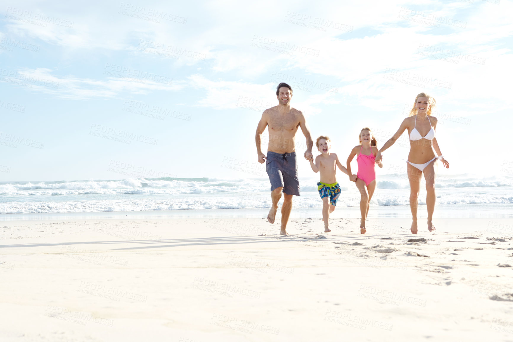 Buy stock photo Family, beach and running on sand with ocean for happiness with beautiful blue sky in summer for travel. People, parents and children with freedom in nature on holiday in Maldives with swimwear.