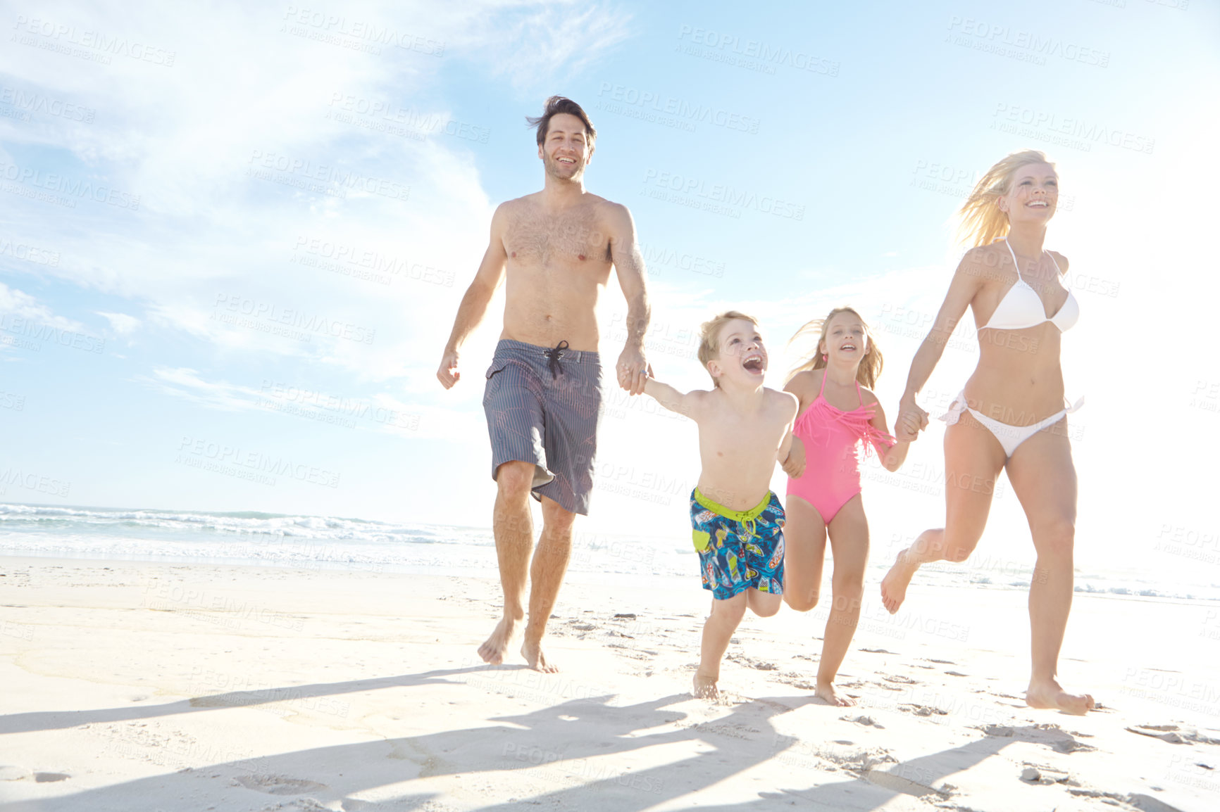 Buy stock photo Love, sky and summer with family on beach, running together in summer for bonding or fun. Happy, nature or smile with mother, father and children on sand by ocean or sea for holiday and vacation