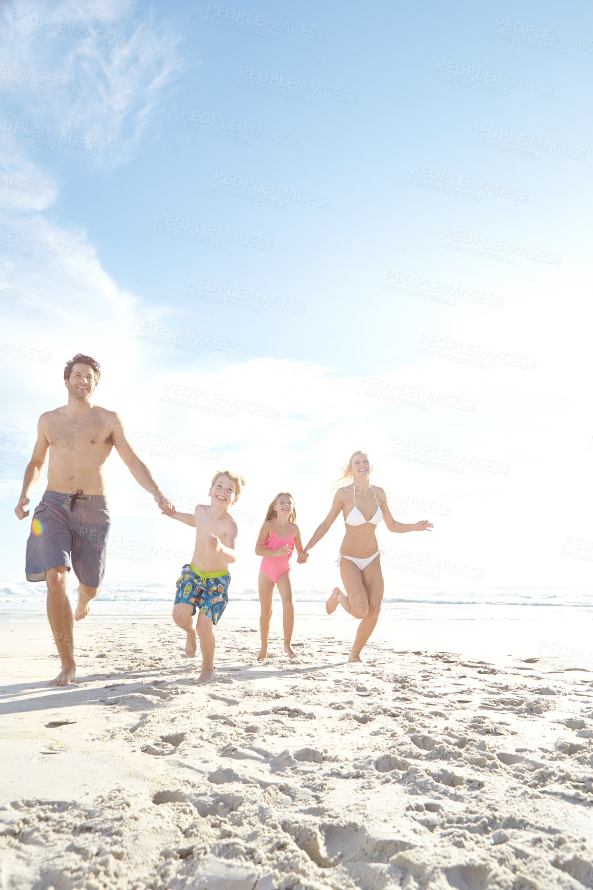 Buy stock photo Running, freedom and excited family holding hands at a beach for summer, fun and bonding in nature on vacation. Travel, energy and happy kids with parents at sea for holiday, celebration and games