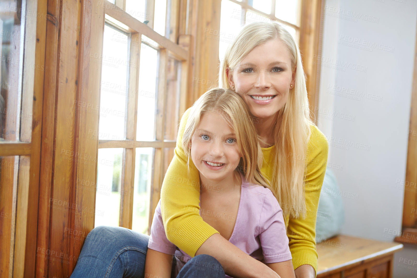 Buy stock photo House, portrait and mother hug girl with happiness in home and support in family with trust. Kid, smile and mom embrace child with kindness in home, apartment or relax in living room together