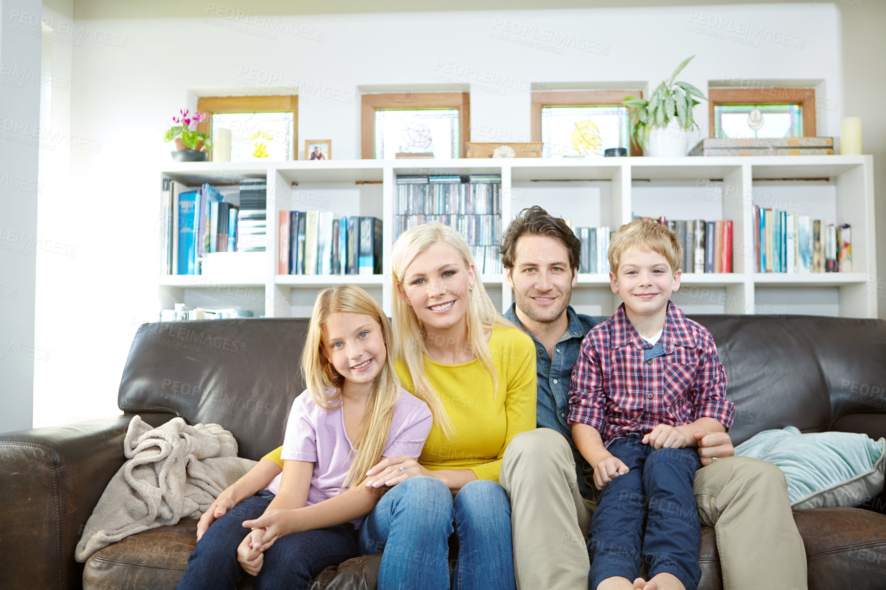 Buy stock photo Happy family, portrait and relax on sofa in home with bonding, confidence and resting on weekend. Parents, children and smile on couch in living room with love, care or comfortable in lounge of house