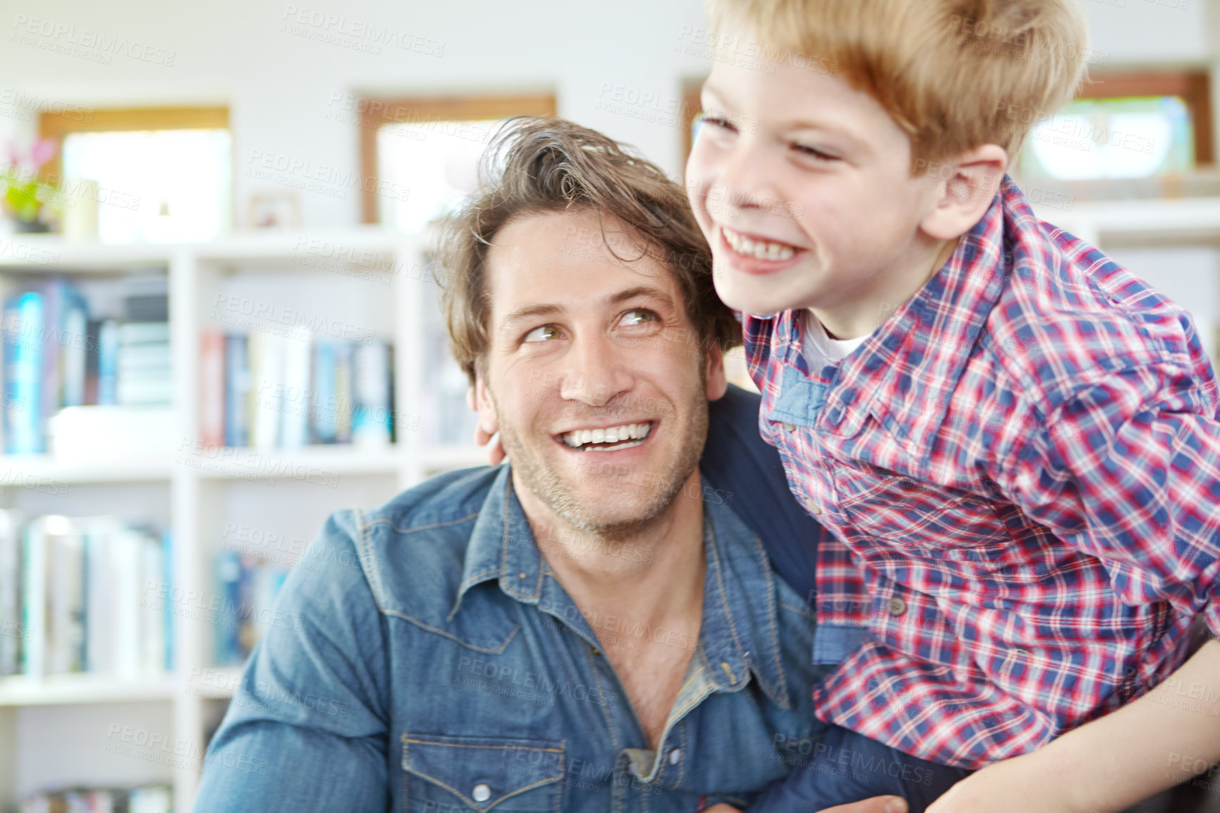 Buy stock photo Shot of a young father and son spending time together at home