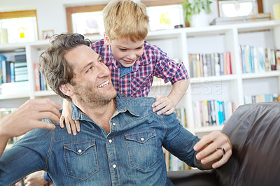 Buy stock photo Shot of a young father and son having fun indoors