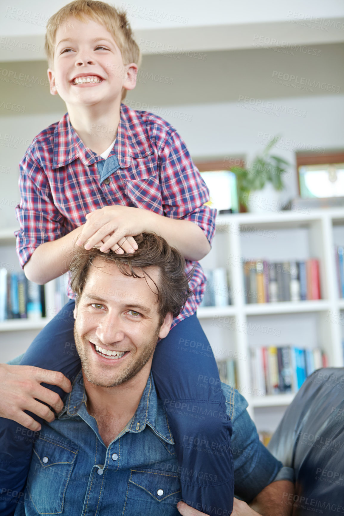 Buy stock photo Shot of a little boy sitting on his father's shoulders