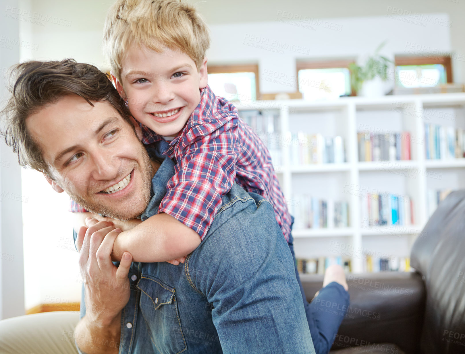 Buy stock photo Portrait, father and child on sofa with embrace, bonding and love in living room for playful family in home. Relax, man and son on couch for happy weekend together with fun, smile and piggy back.